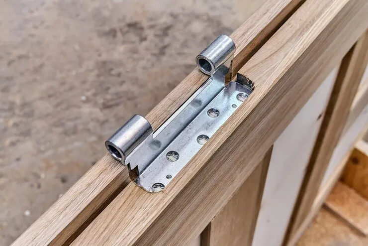 "Close-up of a geared continuous hinge being installed on a commercial hollow metal door in Huntington Beach"