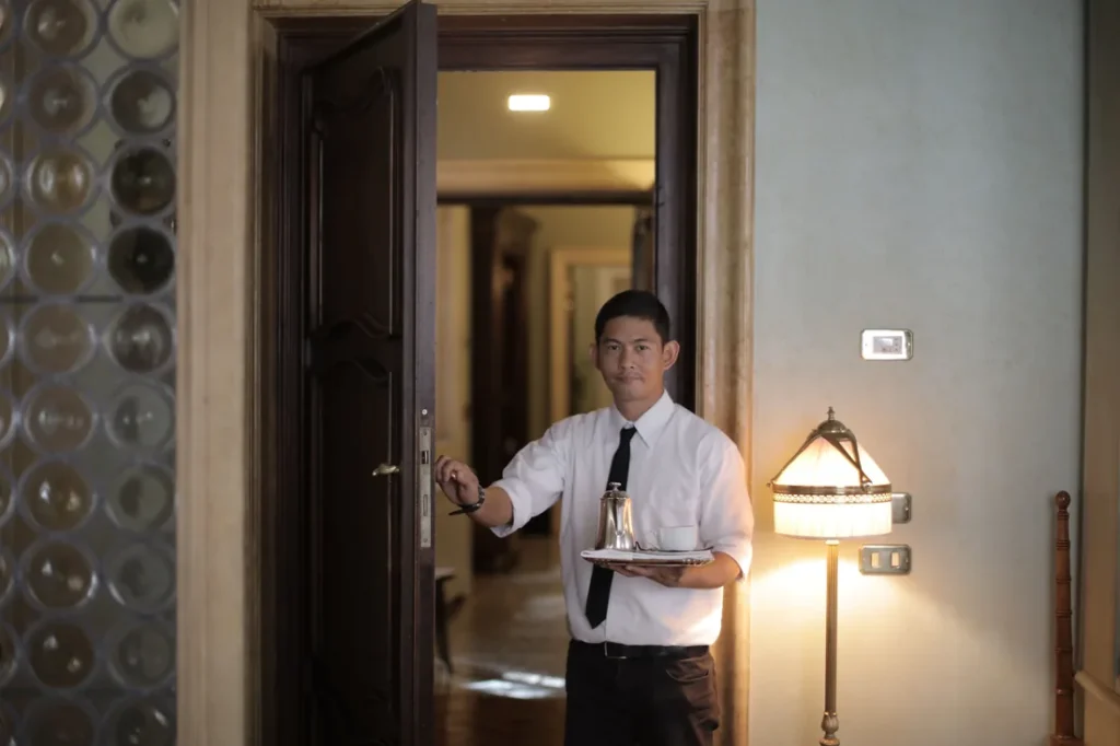 Staff member opening a secured door in a hotel