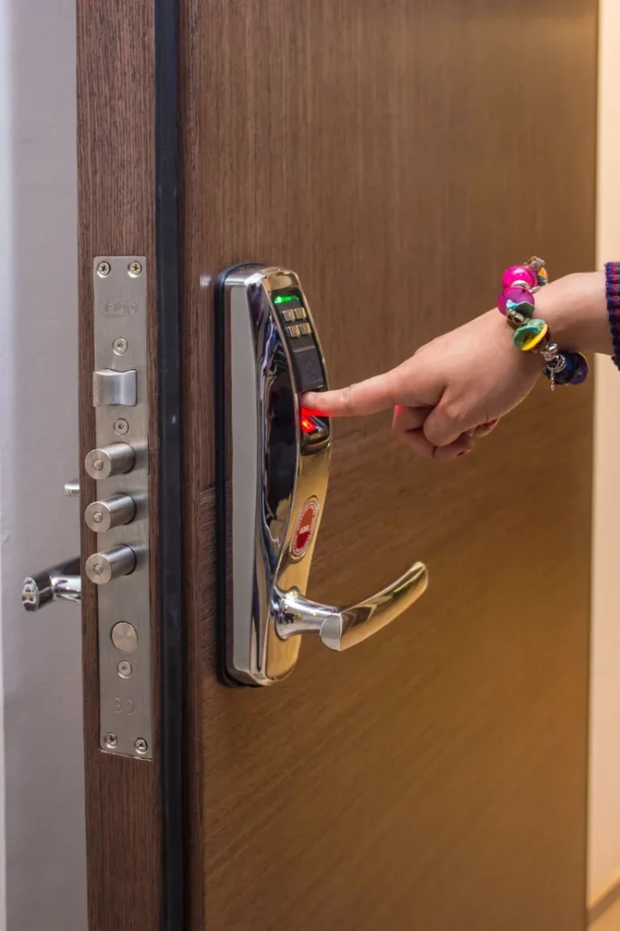Hand holding a key card to an electronic door reader