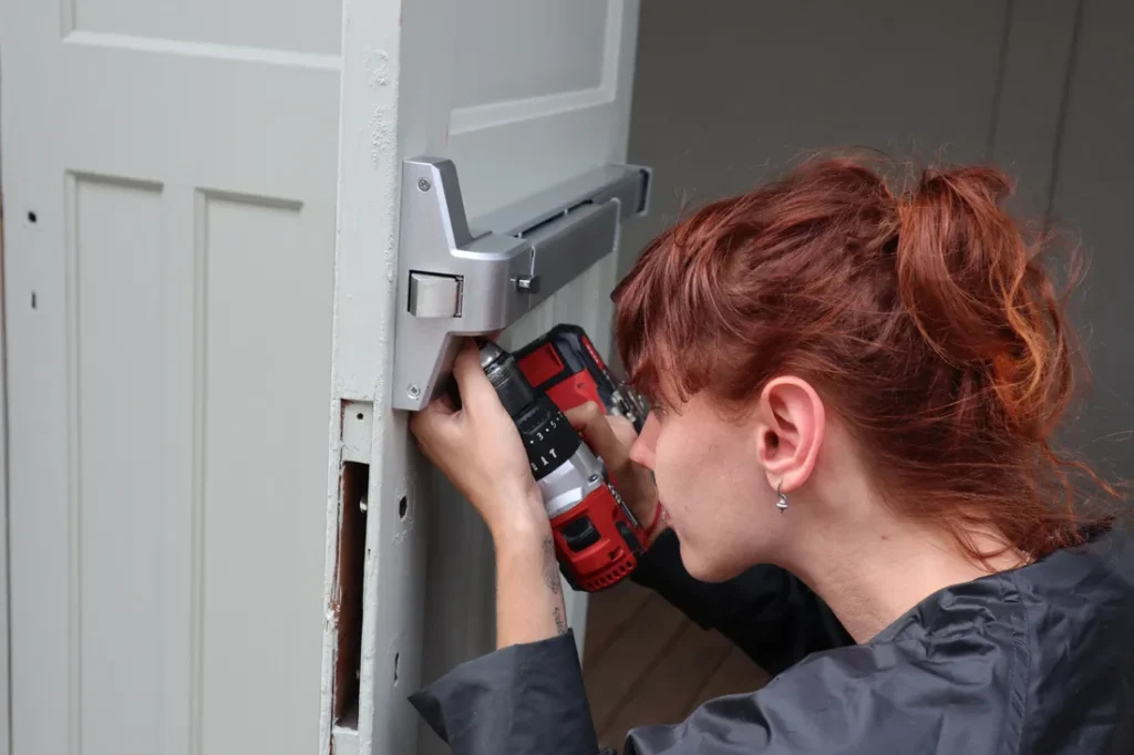 Locksmith rekeying a residential door lock
