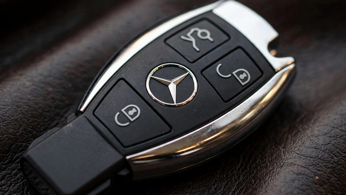 Close up of a Mercedes key fob with silver trim and lock and unlock buttons